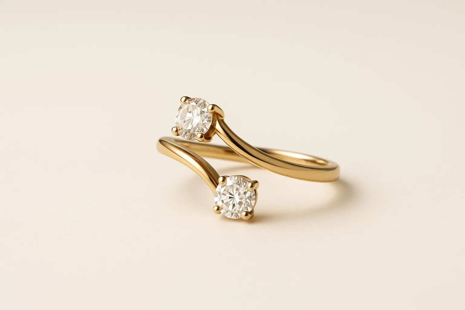A gold ring whose two ends cross behind the top rather than meeting, each arm carrying one round diamond so the stones sit apart.